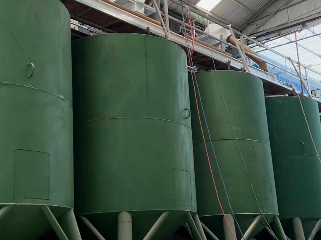 A customer-site walkthrough of batching equipment and the downstream bagging station during installation and commissioning.